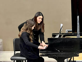 Teaching a young student at the piano